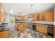 Bright kitchen with stainless steel appliances, wine cooler, granite countertops, and tile floors at 1275 Kelly Nelson Dr, Lawrenceville, GA 30043