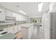Spacious kitchen featuring ample white cabinetry, green countertops, and tile floors at 1275 Kelly Nelson Dr, Lawrenceville, GA 30043