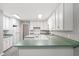Spacious kitchen featuring ample white cabinetry, green countertops, and tile floors at 1275 Kelly Nelson Dr, Lawrenceville, GA 30043