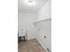 Functional laundry room with utility sink, tile flooring, and storage shelf at 1275 Kelly Nelson Dr, Lawrenceville, GA 30043