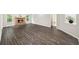 Open-concept living room with wood-look floors and a stone fireplace at 1275 Kelly Nelson Dr, Lawrenceville, GA 30043