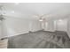 Open-concept living room with gray carpet, neutral walls, and ceiling fan at 1275 Kelly Nelson Dr, Lawrenceville, GA 30043