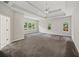 Large main bedroom with tray ceilings, ceiling fan, and many windows at 1275 Kelly Nelson Dr, Lawrenceville, GA 30043