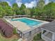Community pool with perimeter fence, seating, and landscaping at 1275 Kelly Nelson Dr, Lawrenceville, GA 30043