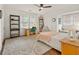 Bright bedroom featuring a ceiling fan, a built-in desk and a cozy sitting area by the window at 2054 Palifox Ne Dr, Atlanta, GA 30307