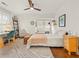Sun-filled bedroom with desk, ceiling fan, wood floors, and an accent rug for a modern, bright feel at 2054 Palifox Ne Dr, Atlanta, GA 30307