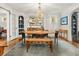 Elegant dining room with a chandelier, hardwood floors, and abundant natural light and access to the kitchen at 2054 Palifox Ne Dr, Atlanta, GA 30307