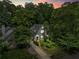 Charming two-story home with dark green paint, lush landscaping, and a welcoming front porch at 2054 Palifox Ne Dr, Atlanta, GA 30307