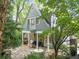 Charming home exterior with a cozy patio, lush landscaping, and inviting curb appeal nestled amongst mature trees at 2054 Palifox Ne Dr, Atlanta, GA 30307
