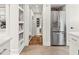 Well-lit kitchen with stainless steel fridge and easy access to the hall and the bathroom at 2054 Palifox Ne Dr, Atlanta, GA 30307