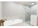 Spa-like bathroom with a soaking tub, glass-enclosed shower, and marble detailing at 2197 Fairway Ne Cir, Brookhaven, GA 30319