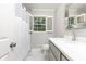 Elegant bathroom features white marble flooring, modern vanity, and a shower-tub combination at 2197 Fairway Ne Cir, Brookhaven, GA 30319