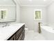 Luxurious bathroom featuring a soaking tub, marble accents, and modern fixtures at 2197 Fairway Ne Cir, Brookhaven, GA 30319