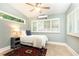 Cozy bedroom with tile floors, neutral walls, plantation shutters, and a ceiling fan providing a calming atmosphere at 2197 Fairway Ne Cir, Brookhaven, GA 30319