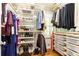 Organized walk-in closet featuring shelves, hanging rods and wooden floor, offering ample storage at 2197 Fairway Ne Cir, Brookhaven, GA 30319