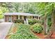 Charming brick home with mature landscaping, black shutters, and a welcoming front porch at 2197 Fairway Ne Cir, Brookhaven, GA 30319