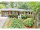 Charming brick home with mature landscaping, black shutters, and a welcoming front porch at 2197 Fairway Ne Cir, Brookhaven, GA 30319