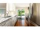 Bright kitchen showcasing stainless steel appliances and white cabinets with access to backyard at 2197 Fairway Ne Cir, Brookhaven, GA 30319