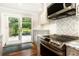 Well-lit kitchen with stainless steel appliances, white cabinets, and granite countertops, plus backyard view at 2197 Fairway Ne Cir, Brookhaven, GA 30319