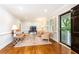 Bright living room featuring wood floors, large windows with shutters, and a welcoming front door at 2197 Fairway Ne Cir, Brookhaven, GA 30319