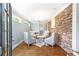 Inviting sitting area features hardwood floors, exposed brick wall and plenty of natural light at 2197 Fairway Ne Cir, Brookhaven, GA 30319