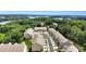 Aerial view of townhomes with a lake and lush greenery at 2340 Manor Pointe Dr, Cumming, GA 30041