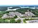 Aerial view of a residential community nestled among lush trees with a lake nearby at 2340 Manor Pointe Dr, Cumming, GA 30041