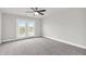 This bedroom features carpet, a ceiling fan, and a glass door to a balcony at 2340 Manor Pointe Dr, Cumming, GA 30041