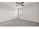 This bedroom features neutral walls, carpet, a ceiling fan, and a bright window at 2340 Manor Pointe Dr, Cumming, GA 30041