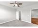 This bedroom features neutral walls, carpet, a ceiling fan, and a closet at 2340 Manor Pointe Dr, Cumming, GA 30041