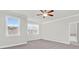 Spacious bedroom with carpet, ample natural light, ceiling fan and view of bathroom at 2340 Manor Pointe Dr, Cumming, GA 30041