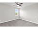 This bedroom features neutral walls, carpet, a ceiling fan, and a bright window at 2340 Manor Pointe Dr, Cumming, GA 30041