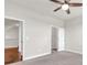 This bedroom features neutral walls, carpet, a ceiling fan, and a closet at 2340 Manor Pointe Dr, Cumming, GA 30041