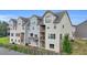 Rear exterior of townhome with multi-level decks and siding, set against a grassy landscape at 2340 Manor Pointe Dr, Cumming, GA 30041