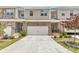 Townhome exteriors with stone accents, two-car garages, and manicured landscaping at 2340 Manor Pointe Dr, Cumming, GA 30041