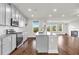 Modern kitchen featuring gray cabinets, granite countertops, stainless appliances and living room view at 2340 Manor Pointe Dr, Cumming, GA 30041