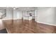 Open-concept living area with hardwood floors connecting the kitchen at 2340 Manor Pointe Dr, Cumming, GA 30041