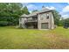 Large, grassy backyard with a deck, staircase, and brick exterior is perfect for outdoor entertaining at 241 Russell Rd, Lawrenceville, GA 30043