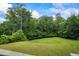 Expansive green backyard with mature trees offering privacy and a serene setting, perfect for outdoor enjoyment at 241 Russell Rd, Lawrenceville, GA 30043