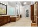 This luxurious bathroom has a large tub, dual vanities, and a walk-in shower at 241 Russell Rd, Lawrenceville, GA 30043