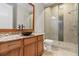 Modern bathroom with wood cabinets, granite countertop, and walk-in shower with decorative tile at 241 Russell Rd, Lawrenceville, GA 30043