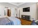 This spacious bedroom features tray ceilings, a mounted TV, and hardwood floors at 241 Russell Rd, Lawrenceville, GA 30043
