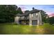 Rear exterior of home shows patio, stairs, garage, and manicured lawn at 241 Russell Rd, Lawrenceville, GA 30043