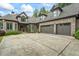 Gorgeous brick home featuring a three-car garage and meticulously maintained landscaping and a large driveway at 241 Russell Rd, Lawrenceville, GA 30043