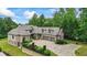 Beautiful brick home featuring manicured landscaping, three-car garage, basketball court, and brick and stone accents at 241 Russell Rd, Lawrenceville, GA 30043