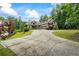 Stately brick home with mature trees, lush landscaping, and a spacious driveway creates a striking curb appeal at 241 Russell Rd, Lawrenceville, GA 30043