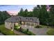 Beautiful brick home featuring manicured landscaping, three-car garage, basketball court, and brick and stone accents at 241 Russell Rd, Lawrenceville, GA 30043