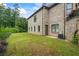 Backyard view shows brick home with enclosed yard at 241 Russell Rd, Lawrenceville, GA 30043
