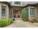 Charming front entrance with custom wood door, brick accents, shutters, and lush landscaping at 241 Russell Rd, Lawrenceville, GA 30043