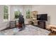 Functional home office space with natural light, modern desk, and ample storage at 241 Russell Rd, Lawrenceville, GA 30043